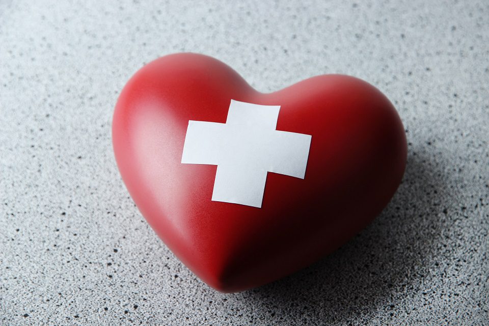 way to save money on funeral costs - Heart with white cross