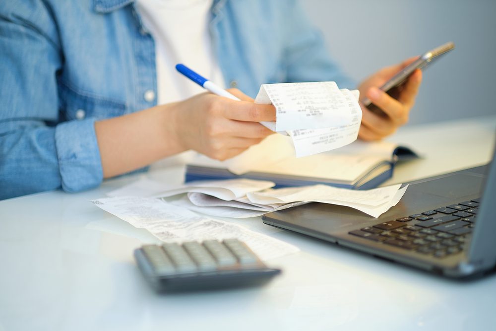 Women calculates her monthly bills